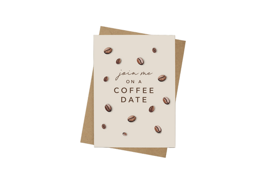 A square cream greeting card with coffee bean illustrations and the text 'join me on a COFFEE DATE', placed on top of a kraft paper envelope against a dark brown background.